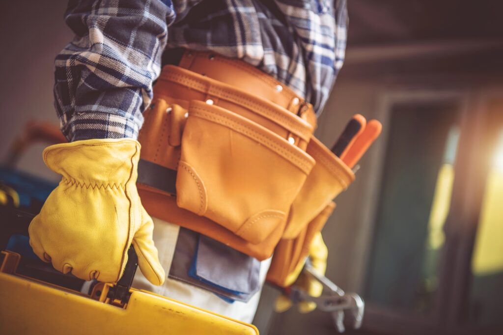 Skilled Tradesperson Using a Toolbox While Working Indoors in a Well-Lit Workshop