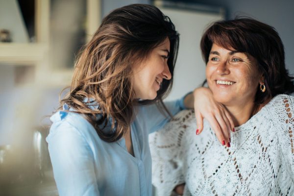 Happy mother and daughter enjoying time together indoors, capturing love and connection.